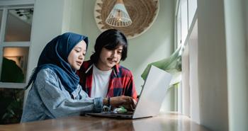 Woman and man typing on computer