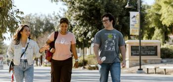 Three Students Walking on Campus