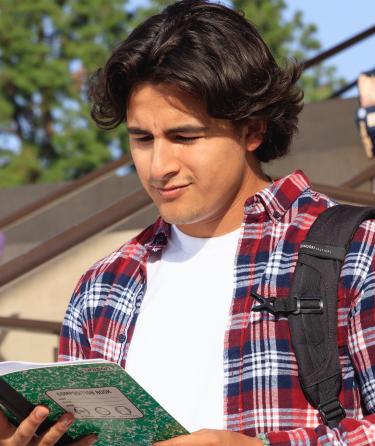 Student Reading His Notebook
