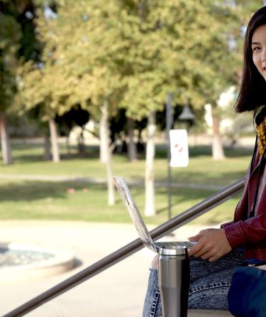Student with Laptop at Campus