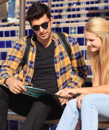 Two Students Reading on Stairs