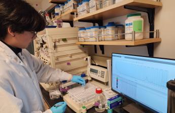 An image of a biotech student is operating a protein purification equipment, FPLC