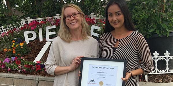 Two Students Holding a Diploma