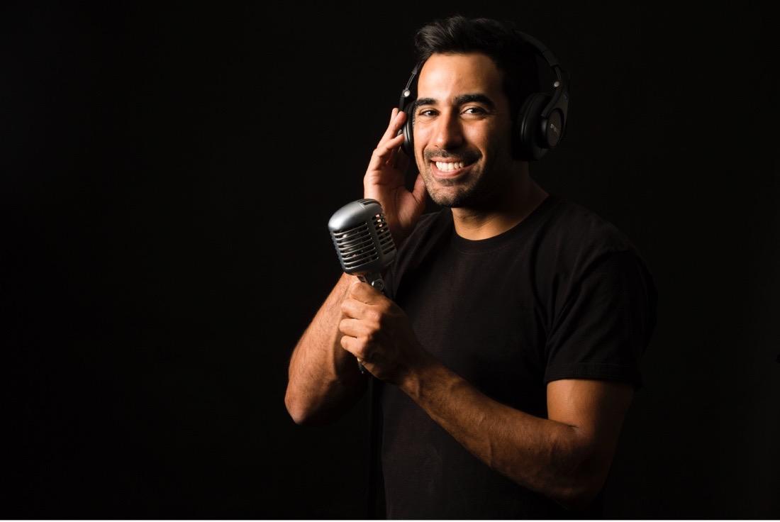 Smiling student recording into a microphone