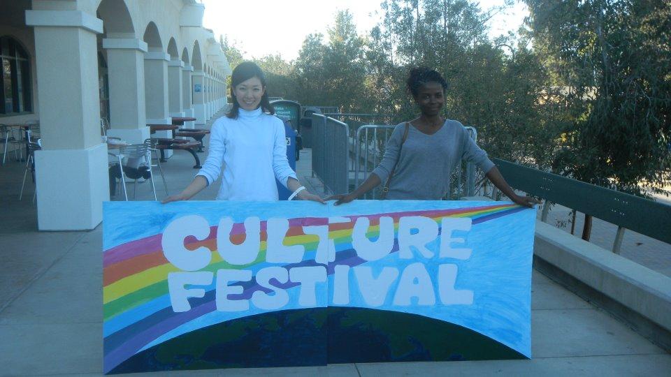Two students holding up a sign that reads "culture festival."