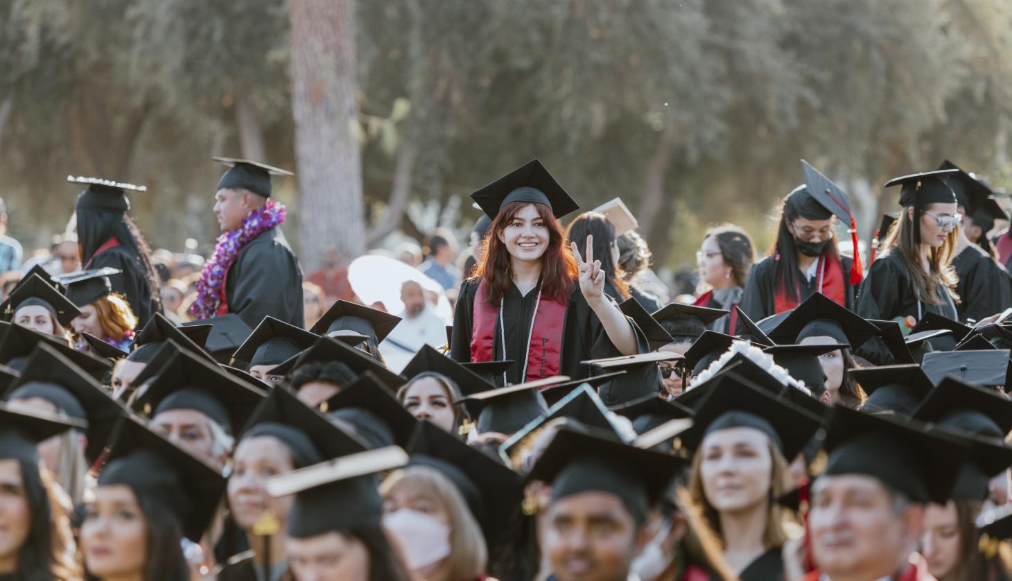 Student in The Middle of Students at Graduation