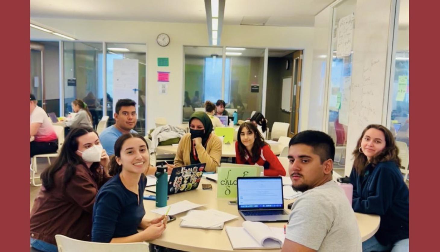 Various students and tutors at a circular tutoring table